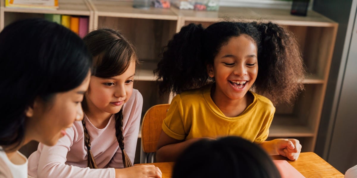 asian-school-teacher-conducting-a-group-study-with-multiethnic-students-in-classroom